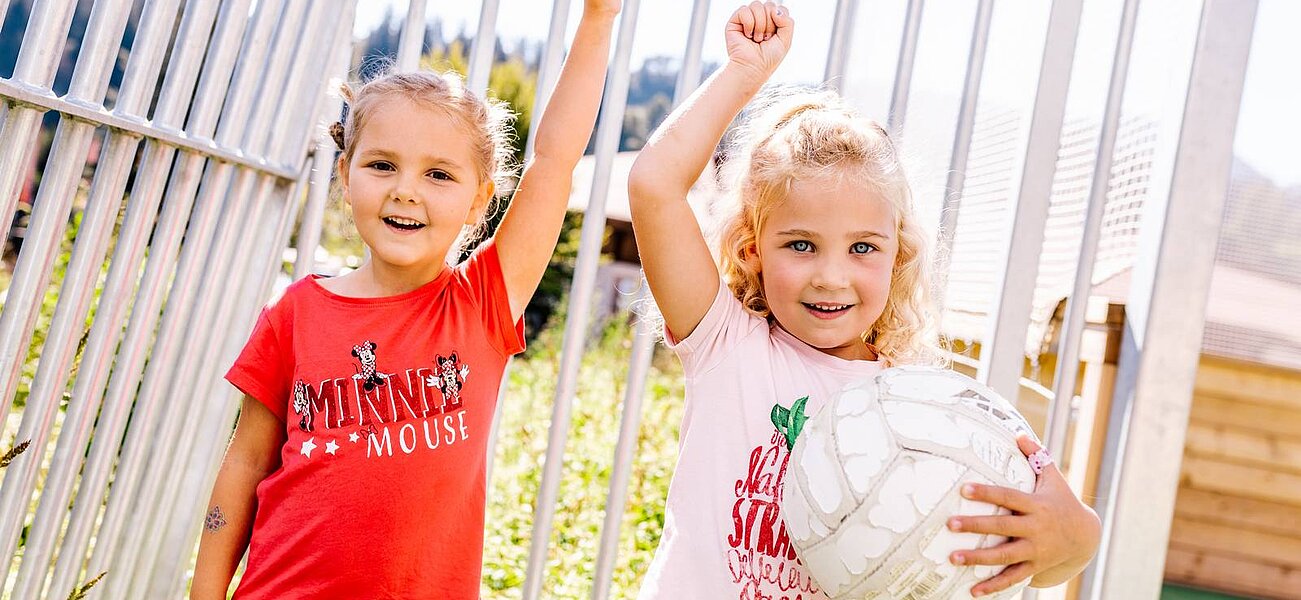 Two girls playing football